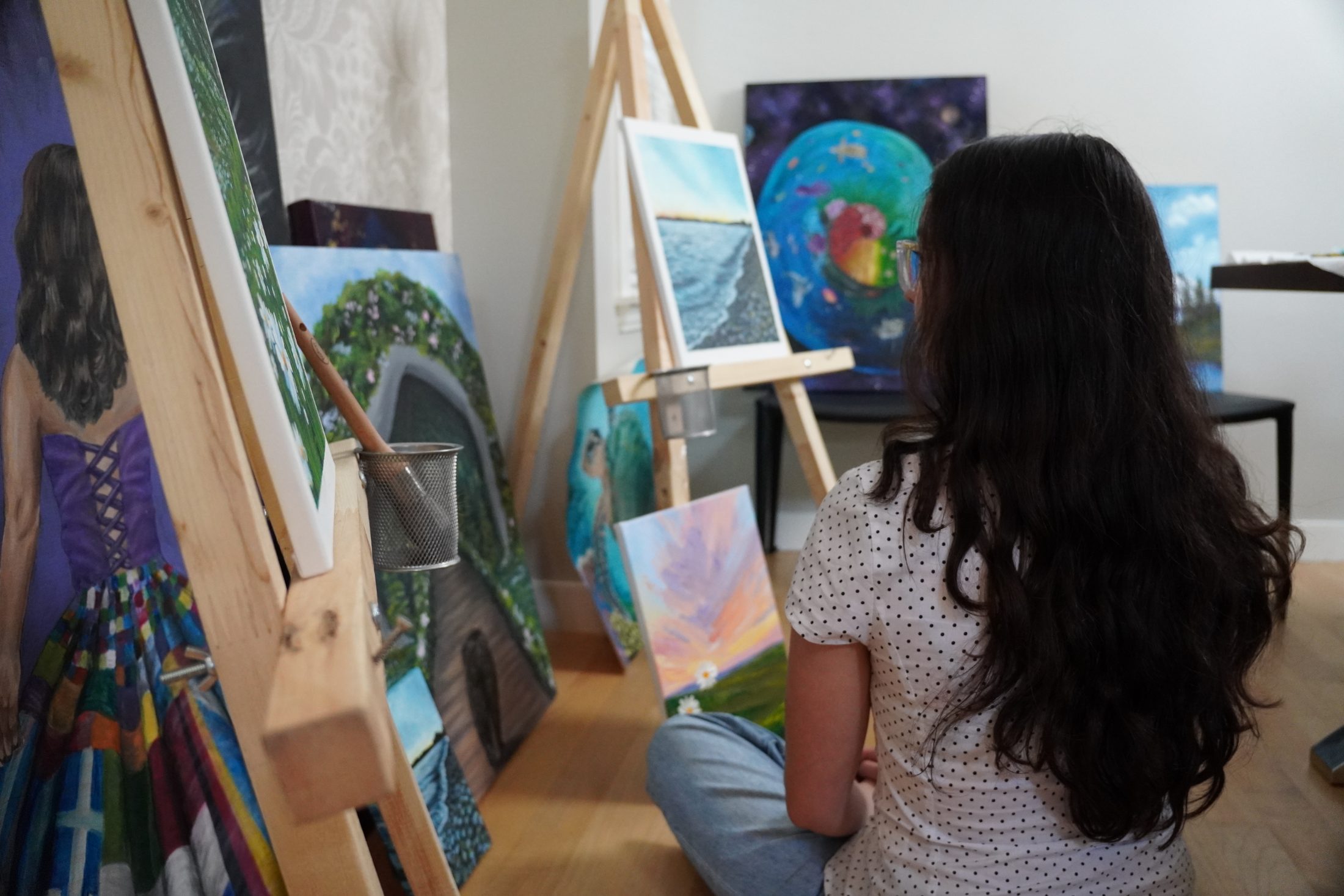 Emma painting in her sunlit studio